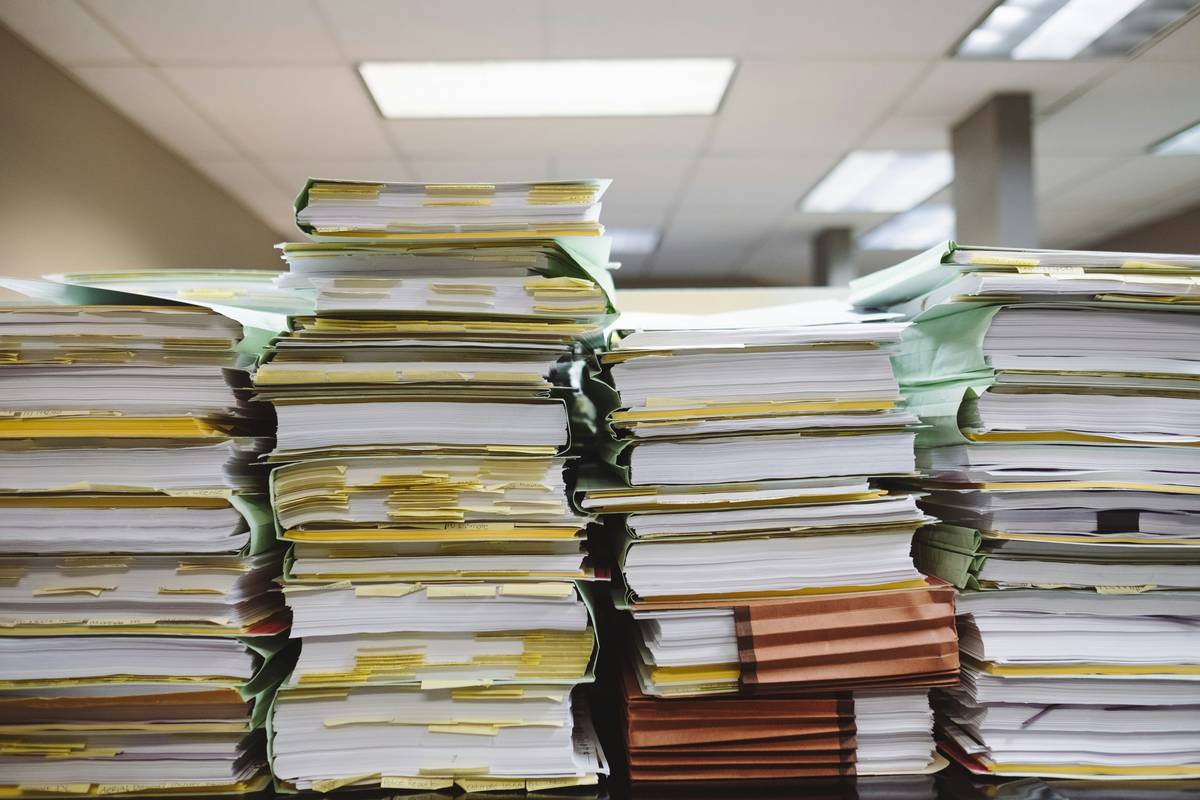 Production manager reviewing weather delay claim documents after delay due to rain