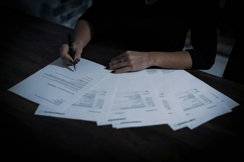 Filmmakers reviewing insurance documents on set