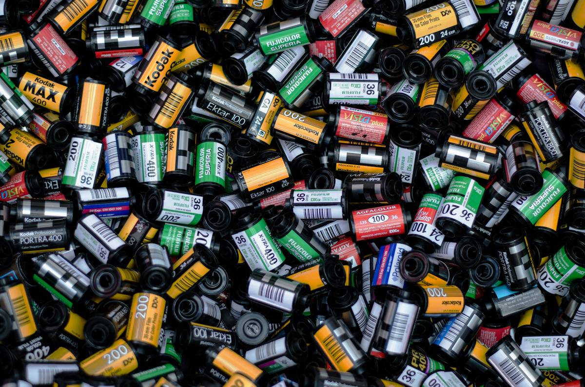 Stack of film canisters labeled with negative film insurance policy numbers
